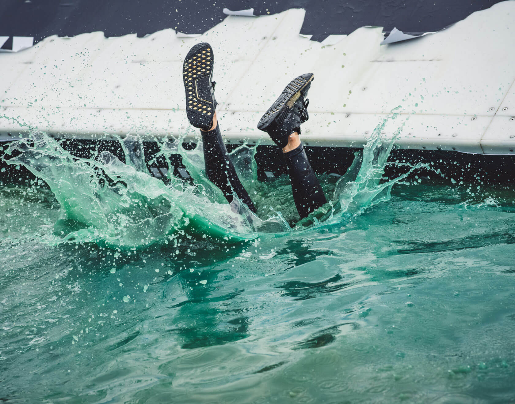 the feet of the participant was the only thing showing as he dive in the water head first
