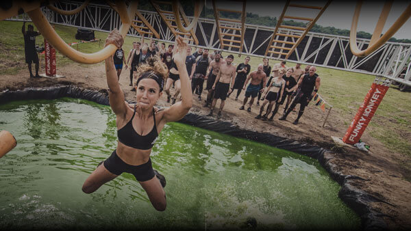 Tough Mudder Participant going through Funky Monkey.